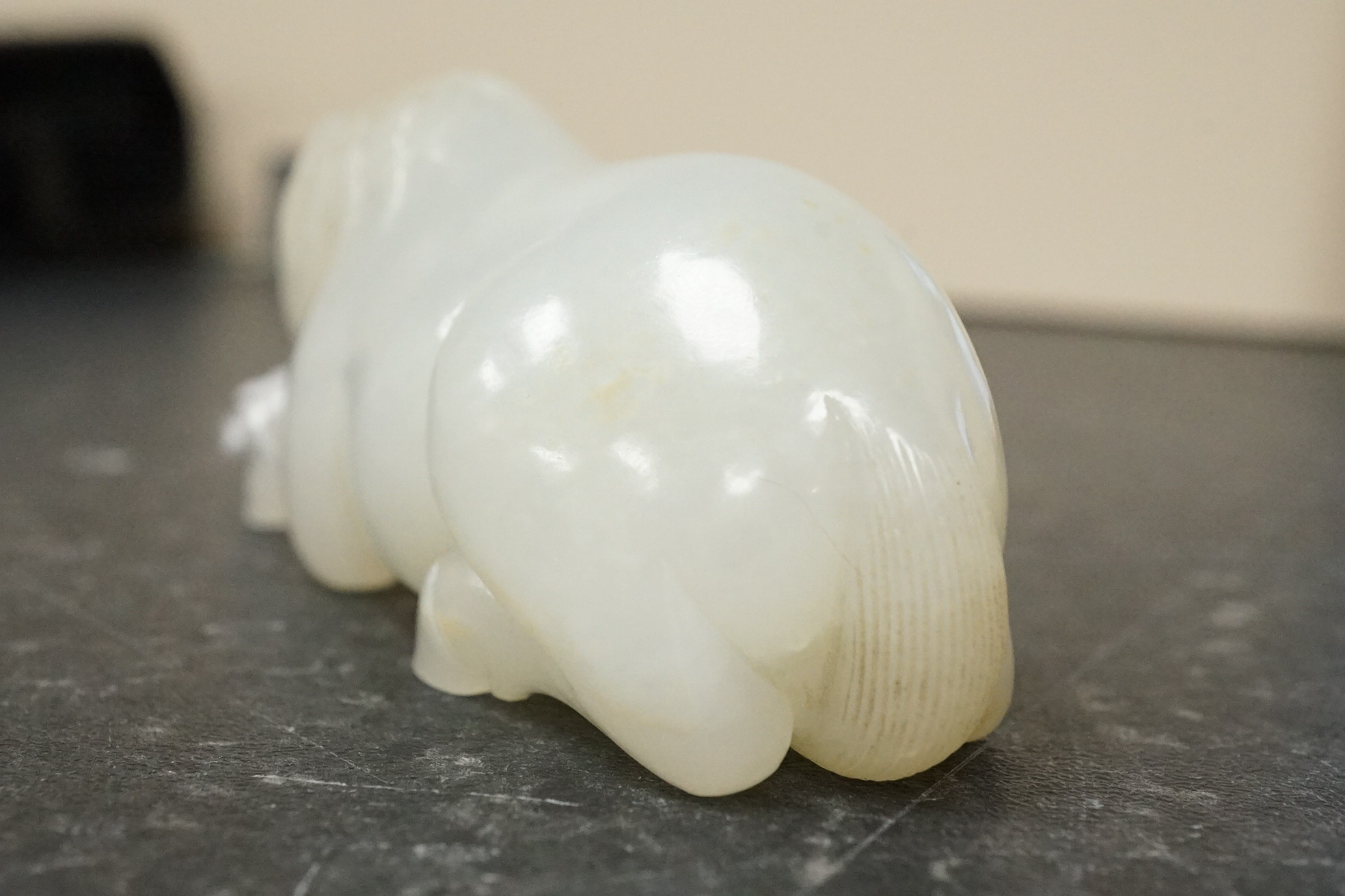 A Chinese white jade figure of a recumbent horse